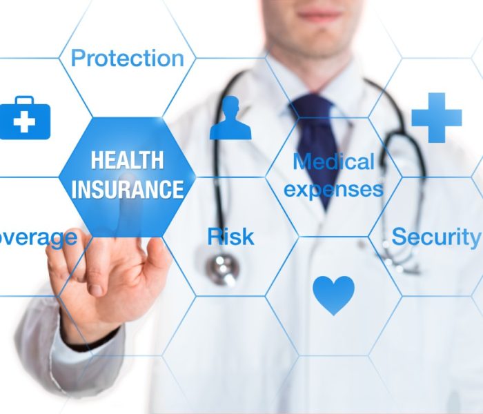 Health insurance concept with words coverage, protection, risk, and security on a virtual screen and a medical doctor touching a button, isolated on white background